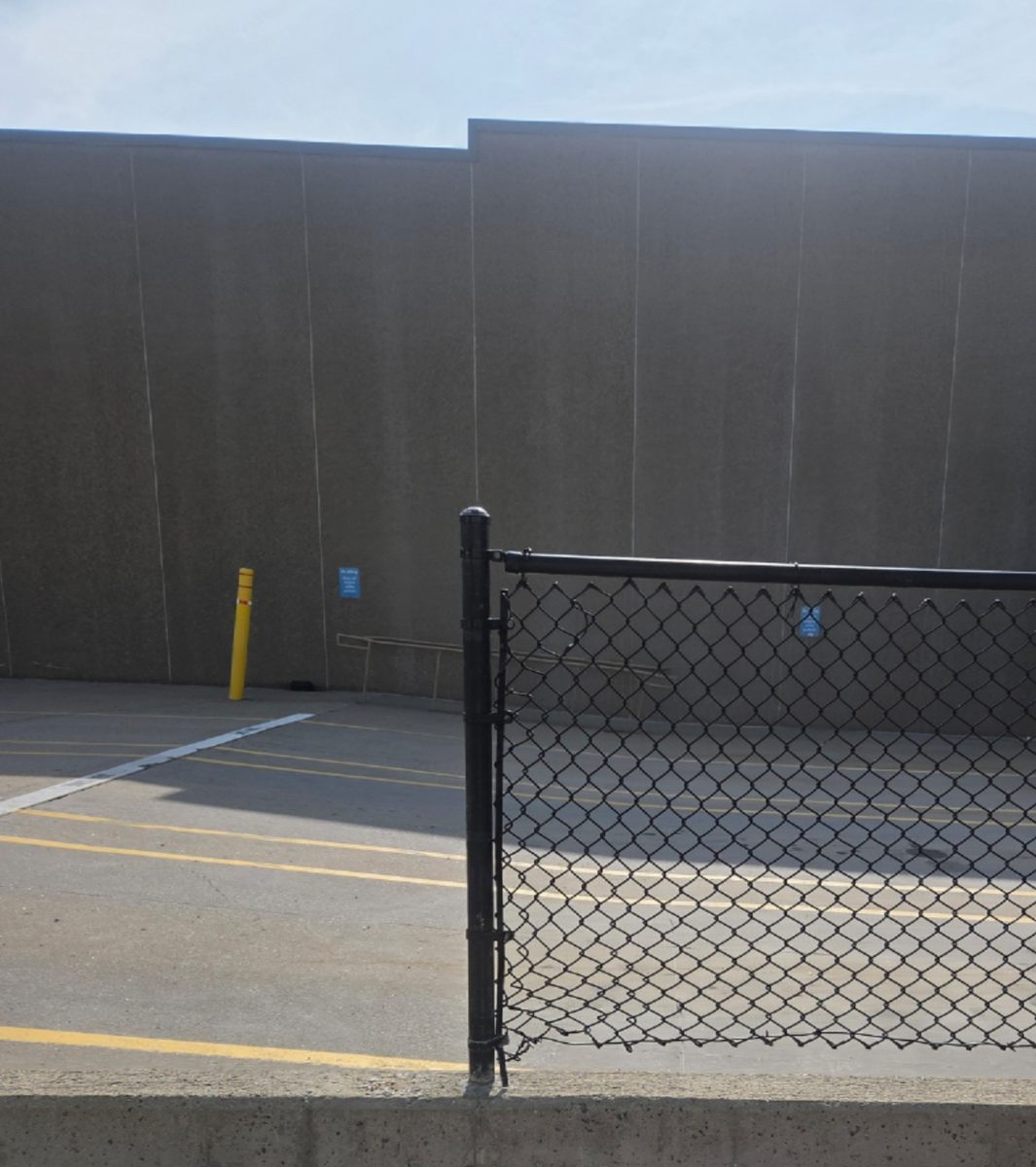 After: The same chain-link gate repaired, rehung and closed on its post