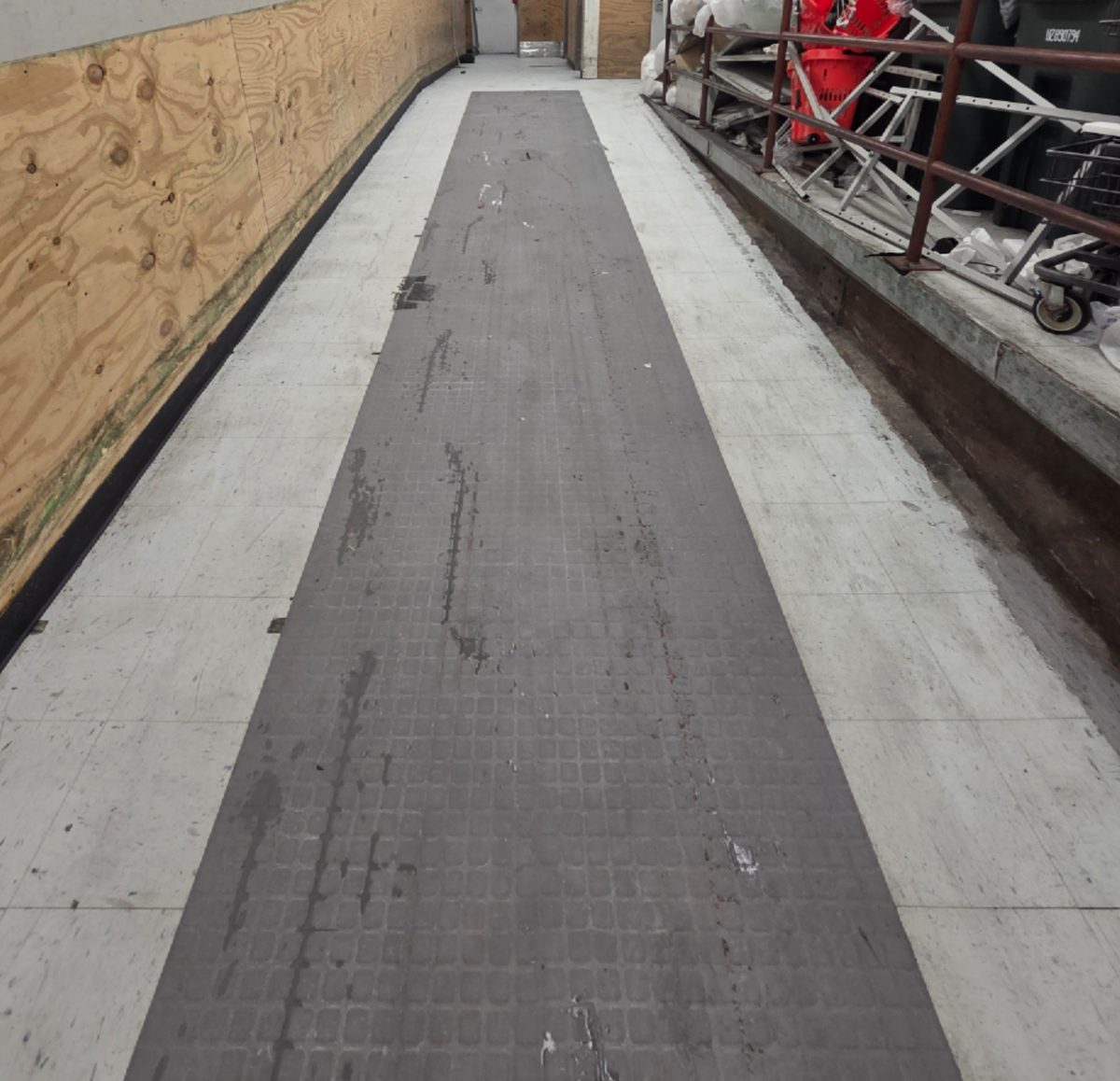 After: The same ramp floor cleaned, with a new anti-slip mat runner down the center